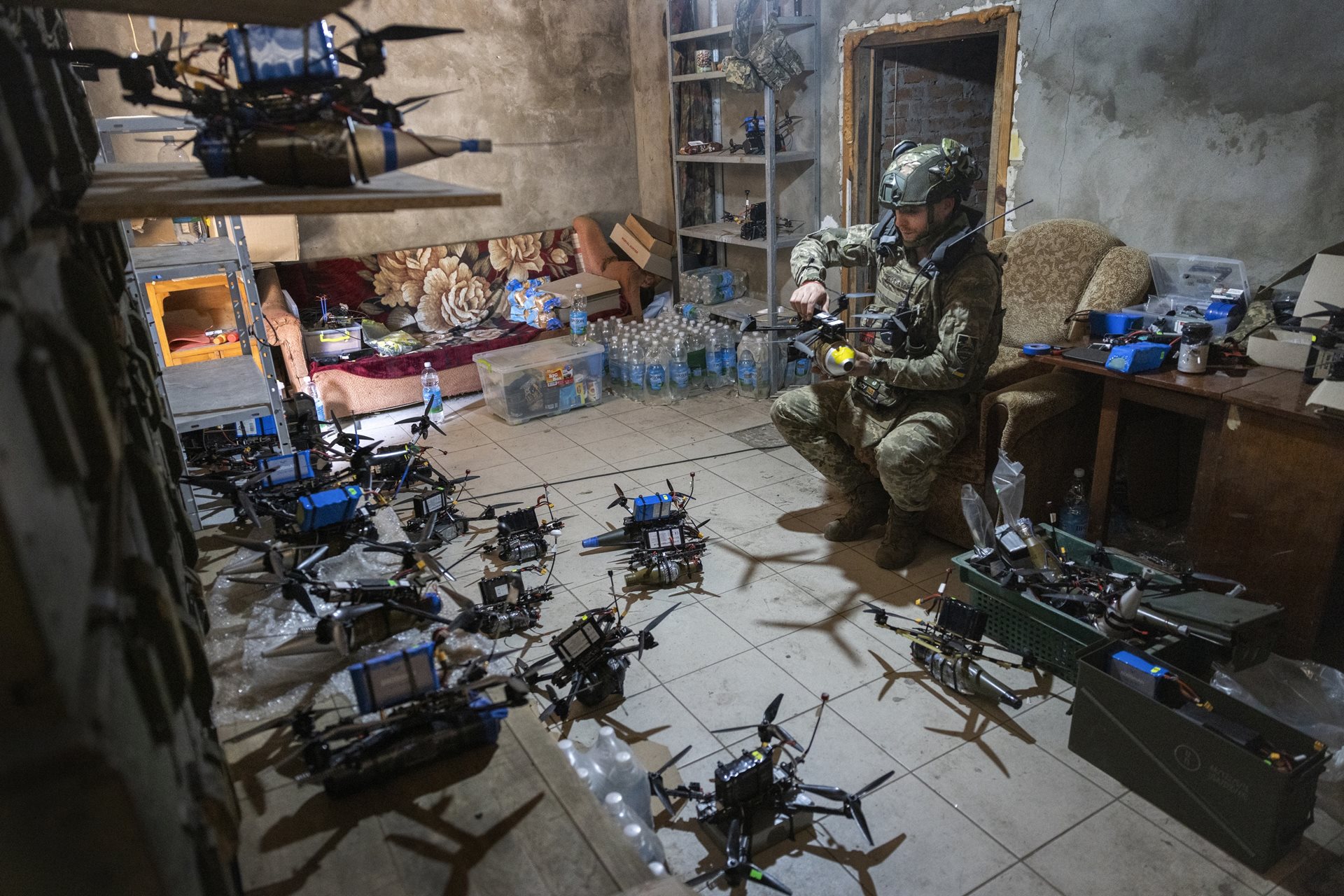 A Ukrainian soldier, code-named &ldquo;Trader,&rdquo; of the Achilles drone strike battalion, prepares FPV drones for attack missions on Russian positions in the Kharkiv region of Ukraine.